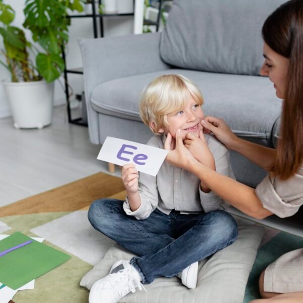 young-woman-doing-speech-therapy-with-little-blonde-boy