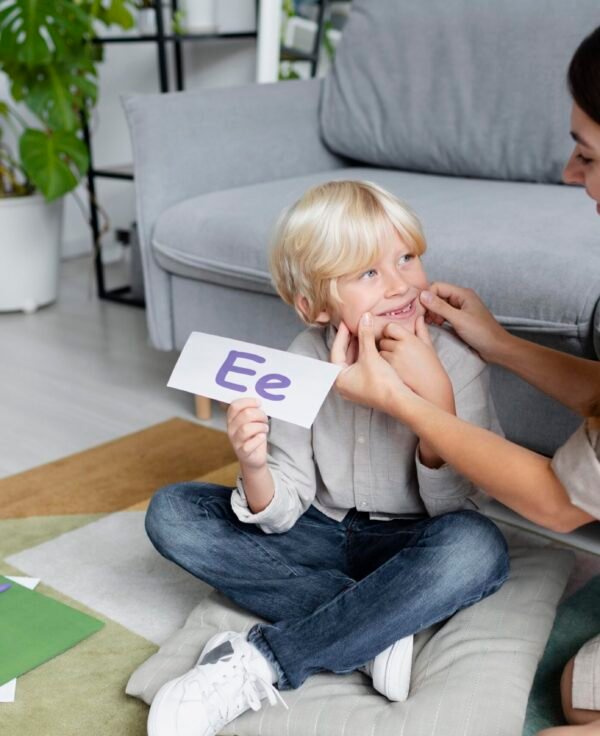 young-woman-doing-speech-therapy-with-little-blonde-boy